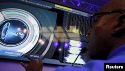 A Genworth brand ambassador points to a hearing display during a Genworth R70i Aging Experience demonstration at the Liberty Science Center in Jersey City, New Jersey, April 5, 2016. 