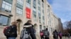 FILE - Students and passers-by walk past an entrance to Boston University College of Arts and Sciences, in Boston, Massachusetts, Nov. 29, 2018.