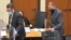 In this image from video, defense attorney Eric Nelson, left, and defendant Derek Chauvin take their seats ahead of jury selection, March 10, 2021, at the Hennepin County Courthouse in Minneapolis.