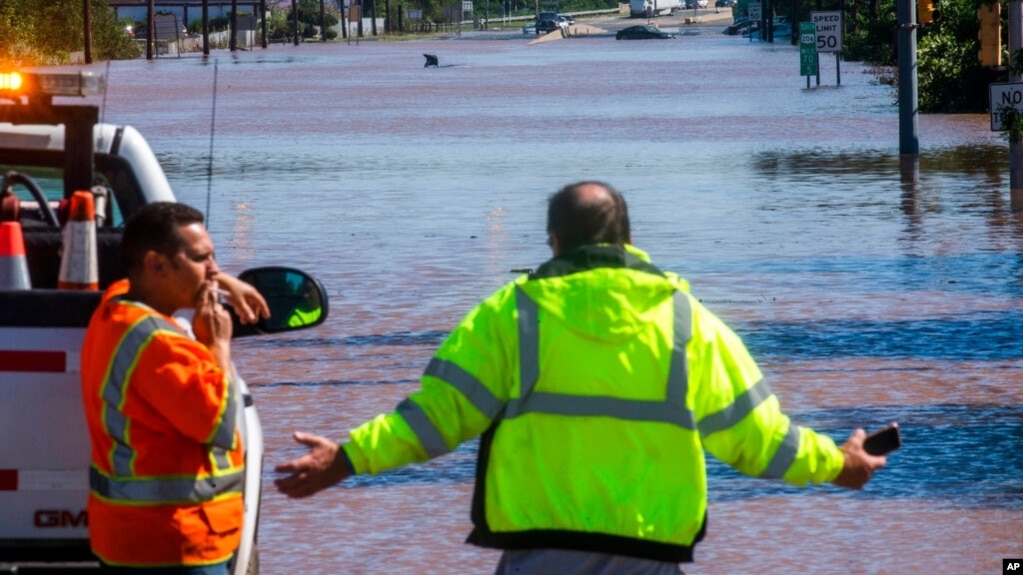 People look at U.S. Route 206, flooded as a result of the remnants of Hurricane Ida, in Somerville, N.J., Sept. 2, 2021. 