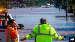 People look at U.S. Route 206, flooded as a result of the remnants of Hurricane Ida, in Somerville, N.J., Sept. 2, 2021. 