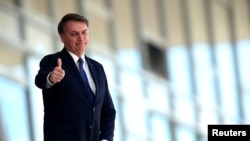 Brazil's President Jair Bolsonaro gestures as he stands at the ramp of the Planalto Palace, amid the coronavirus outbreak in Brasilia, Brazil, April 27, 2020.