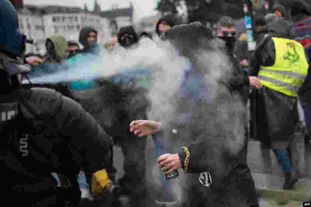A woman reacts as tear gas is sprayed right into her face during a demonstration in Nantes, France.