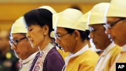 Burma's opposition leader Aung San Suu Kyi (2nd L) along with other elected members of parliament reads her parliamentary oath at the lower house of parliament during a session in Naypyidaw, May 2, 2012.