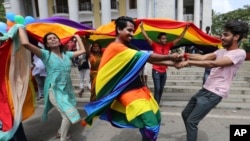 Members of the LGBT community dance to celebrate after the India's top court struck down a colonial-era law that made homosexual acts punishable by up to 10 years in prison, in Bangalore, India, Sept. 6, 2018. 