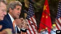 U.S. Secretary of State John Kerry, second left, speaks during a joint session on Climate Change issues with Chinese officials at the Diaoyutai State Guesthouse in Beijing, China, July 9, 2014.