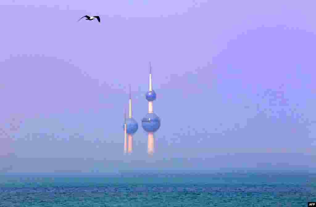 Fog covers the base of the Kuwait Towers, in the capital Kuwait City.