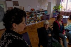 Angela Hovakimyan, center and her daughters, Evelina Sangsyan, left, and Elmira Avagyan say they fled their homes, but they will return as soon as possible on Oct. 8, 2020 in Goris, Armenia. (Yan Boechat/VOA)