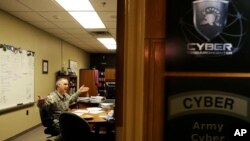 FILE - Col. Gregory Conti, military intelligence director of the Cyber Research Center at the United States Military Academy, sits in his office in West Point, New York, April 9, 2014.