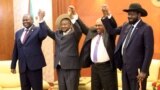 From right, South Sudan's President Salva Kiir, Sudan's President Omar Al-Bashir, Uganda's President Yoweri Museveni and rebel leader Riek Machar hold hands during a South Sudan peace meeting in Khartoum, Sudan, June 25, 2018. 