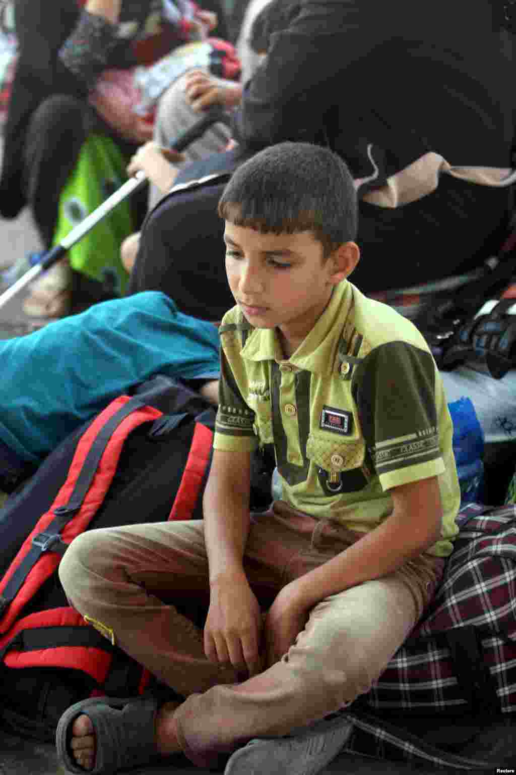 An internally displaced Iraqi Sunni boy sits with his family, who fled the violence in the city of Ramadi, on the outskirts of Baghdad, May 19, 2015.&nbsp;