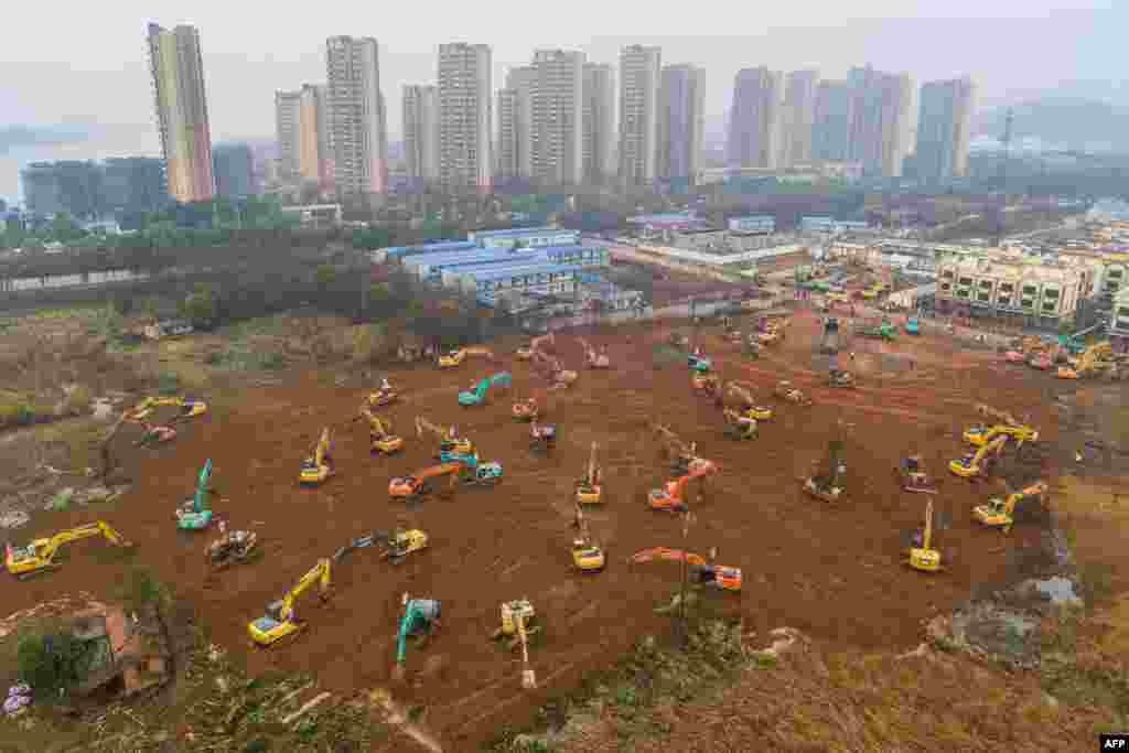 Excavators work at the construction site of a new hospital being built in a staggering 10 days to treat patients from a virus outbreak in Wuhan in China&#39;s central Hubei province.