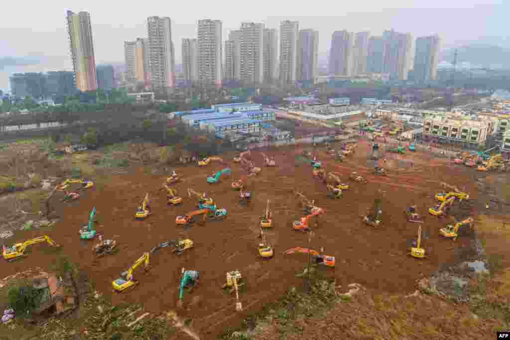 Excavators work at the construction site of a new hospital being built in a staggering 10 days to treat patients from a virus outbreak in Wuhan in China's central Hubei province.