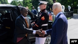 FILE — US President Joe Biden greets Kenya’s President William Ruto upon his arrival at the South Portico of the White House in Washington, DC, on May 22, 2024. 