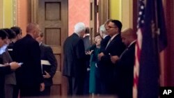 FILE - Republican senators gather to meet with Senate Majority Leader Mitch McConnell on the Repblican effort to overhaul the U.S. tax code, on Capitol Hill, in Washington, Dec. 1, 2017. A vote on the bill could be held as early as next week.