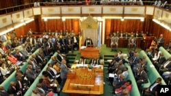 Uganda's Prime Minister, standing center-left, addresses Members of Parliament in Kampala, Uganda, Sept. 21, 2017.