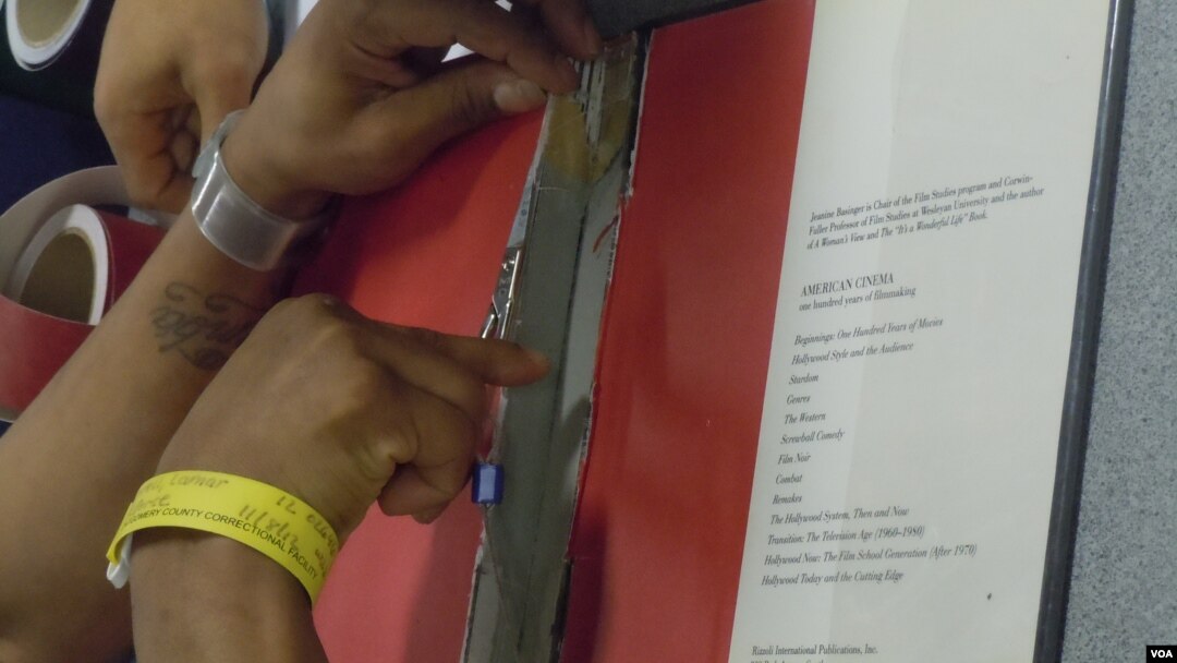 An inmate at the Montgomery County Correctional Facility in Boyds, Maryland, repairs a damaged library book. (VOA/J. Spierling ) 
