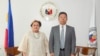 This handout photo taken on October 19, 2026 and released by the Department of Foreign Affairs shows Philippine Secretary of the Department of Foreign Affairs Maria Theresa Lazaro (L) and China's Ambassador to the Philippines Jing Quan.