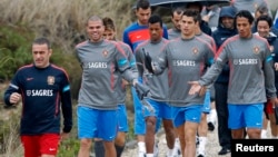 El entrenador de Portugal, Paulo Bento (izquierda) guía a sus jugadores a una sesión de entrenamiento, con Pepe, Nani, Crisitano Ronaldo y Bruno Alves al frente.