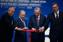 Turkey's President Recep Tayyip Erdogan, 2nd right and Russia's President Vladimir Putin, 2nd left, symbolically open a valve during a ceremony in Istanbul for the inauguration of the TurkStream pipeline, Jan. 8, 2020.