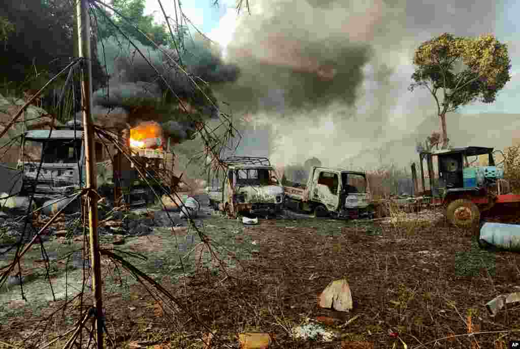 In this photo provided by the Karenni Nationalities Defense Force (KNDF), smokes and flames billow from vehicles in Hpruso township, Kayah state, Myanmar, Dec. 24, 2021.&nbsp;Aid group Save the Children said it was suspending operations in Kayah state after two staff members went missing in an attack by government troops that left at least 30 people dead, including women and children, with many bodies burnt. &nbsp;