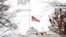 A flock of geese flies past an American flag at half-staff over the White House, Saturday, Dec. 1, 2018, in Washington. (AP Photo/Jacquelyn Martin)