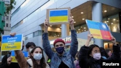 Demonstrators hold placards as they take part in a rally against Russia's invasion of Ukraine, in Taipei, Taiwan February 25, 2022.