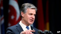 Director of the Federal Bureau of Investigation, Christopher Wray, gestures as he speaks during a graduation ceremony for students of the Federal Bureau of Investigations National Academy at the FBI training facility in Quantico, Virginia,June 7, 2019. 