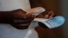 A voter casts his ballot in the general elections in Harare, Zimbabwe, July 30, 2018. 