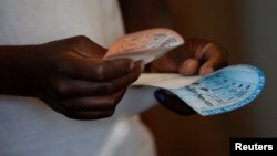 A voter casts his ballot in the general elections in Harare, Zimbabwe, July 30, 2018. 