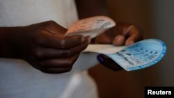 A voter casts his ballot in the general elections in Harare, Zimbabwe, July 30, 2018. 