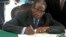 Zimbabwe President Robert Mugabe signs Zimbabwe's new constitution into law in Harare, May 22, 2013.