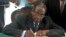 FILE - President Robert Mugabe signs Zimbabwe's new constitution into law in Harare, May 22, 2013.