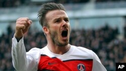 An April 6, 2013 photo, shows PSG's David Beckham celebrating after scoring a goal against Rennes during their French League One soccer match, in Rennes, western France. 