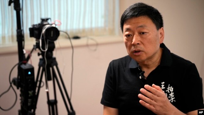 FILE- Wang Zhi'an speaks during an interview with the Associated Press in Tokyo on Oct. 5, 2022. Wang, as well as artist-turned-dissident Li Ying, said in separate posts Feb. 25, 2024, that police were interrogating people who followed them on social media.