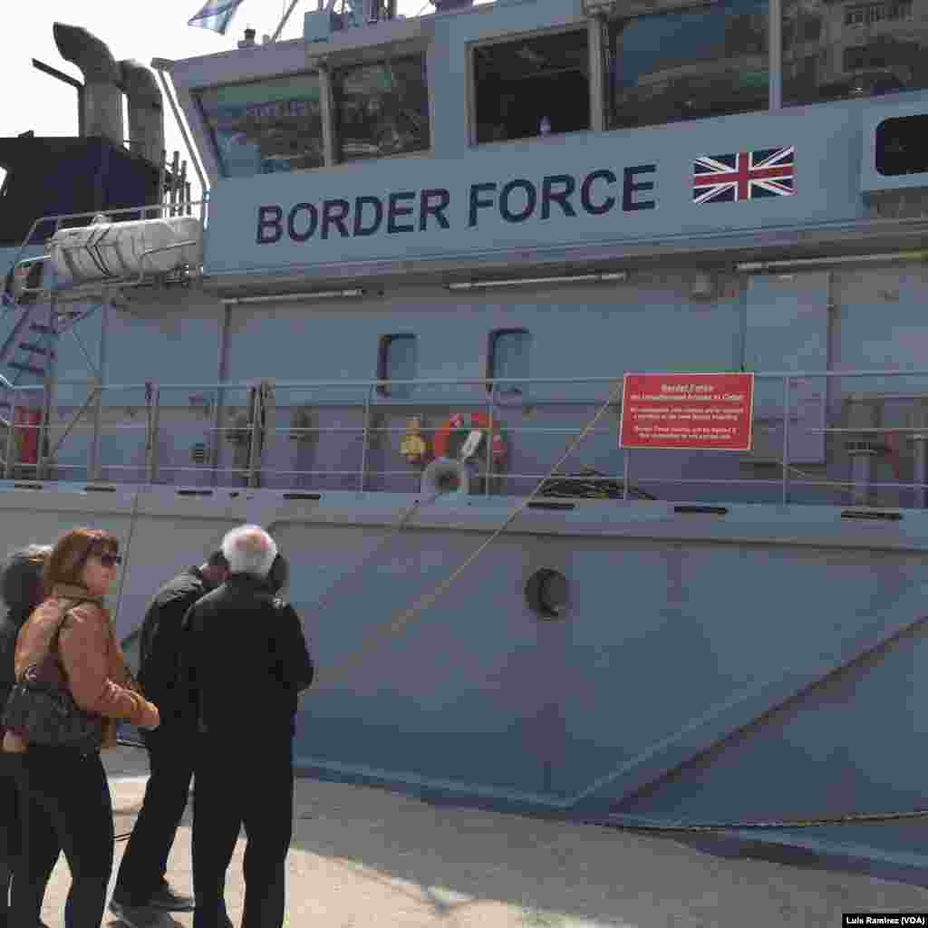 Residents of Lesbos peer into a British cutter that has been sent as part of a European Uunion force to assist Greece in returning migrants to Turkey, April 3, 2016.