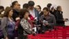 FILE - Nonresident visitors to the United States wait in line at immigration control after arriving at McCarran International Airport, in Las Vegas, Dec. 13, 2011.