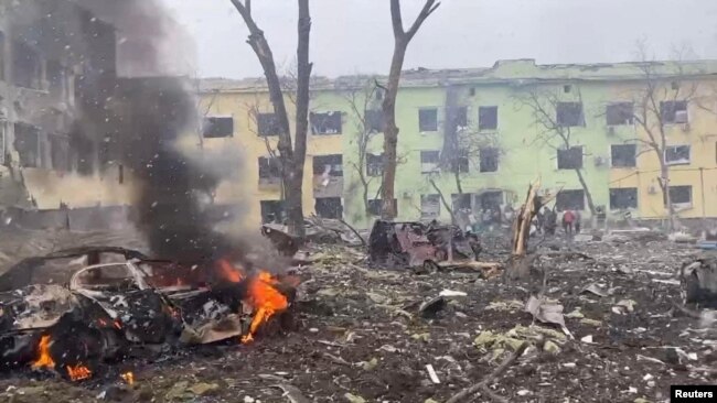 A view shows cars and a building of a hospital destroyed by an airstrike in Mariupol March 9, 2022. (Press service of the National Police of Ukraine/Handout via REUTERS)