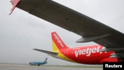 FILE - A VietJet airplane is seen at Noi Bai international airport in Hanoi, Vietnam, Sept. 25, 2013.