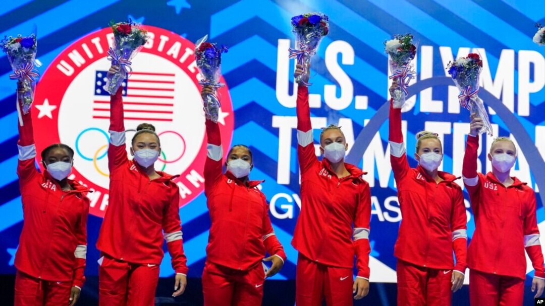Members of the U.S. Women's Olympic Gymnastic Team, from left, Simone Biles, Suni Lee, Jordan Chiles, and Grace McCallum plus individual members MyKayla Skinner and Jade Carey wave after the U.S. Olympic Gymnastics Trials, in St. Louis, June 27, 2021.