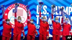 Members of the U.S. Women's Olympic Gymnastic Team, from left, Simone Biles, Suni Lee, Jordan Chiles, and Grace McCallum plus individual members MyKayla Skinner and Jade Carey wave after the U.S. Olympic Gymnastics Trials, in St. Louis, June 27, 2021.