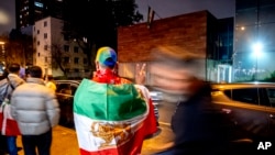 Iranians living in Frankfurt gather in front of the Iranian Consulate that was shut down in response to the execution of Jamshid Sharmahd, who was kidnapped in Dubai in 2020 by Iranian security forces, in Frankfurt, Germany, Oct. 31, 2024. 