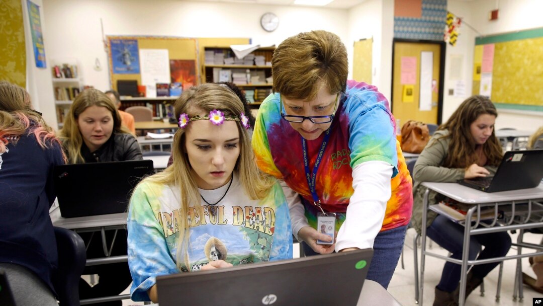 FILE — Teacher Carol Mowen, right, works with student Kirsten Delauney on an oral history project at Washington County Technical High School in Hagerstown, Md. 