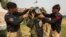 A technician from Pakistan's top bomb disposal unit is helped into his protective suit during a demonstration at at the unit's headquarters in Peshawar on Sept. 12, 2013. 