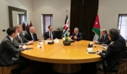FILE - Presidential advisers Jared Kushner, center left, and Jason Greenblatt, third left, meet with Jordan's King Abdullah II, center right, and his advisers, in Amman, Jordan, May 29, 2019.