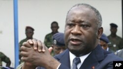 Ivory Coast's President Laurent Gbagbo attends an official funeral ceremony in Abidjan in this November 15, 2003 file photo. Ivory Coast's incumbent leader Laurent Gbagbo has been arrested, a spokeswoman for forces loyal to his rival presidential claimant