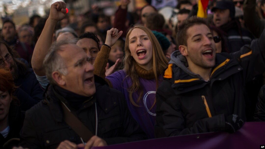 People shout slogans during a Podemos party march in Madrid, Jan. 31, 2015.