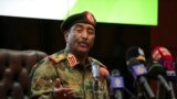 FILE: Sudan's head of the military and de-facto government head, Gen. Abdel-Fattah Burhan, speaks during a press conference at the General Command of the Armed Forces in Khartoum, Sudan, Oct. 26, 2021.