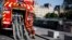 A firefighter checks his phone as he rests near the Notre Dame cathedral, in Paris, April 19, 2019.