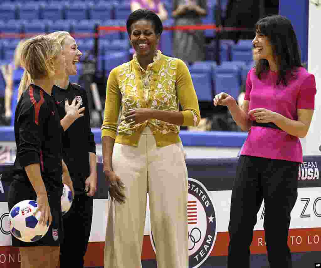 U.S. first lady Michelle Obama and her British counterpart, Samantha Cameron, talk with U.S. Women's National Soccer Team players at a mini-Olympics competition in celebration of the 2012 London Summer Olympics and Mrs. Obama's Let's Move! initiative. (AP